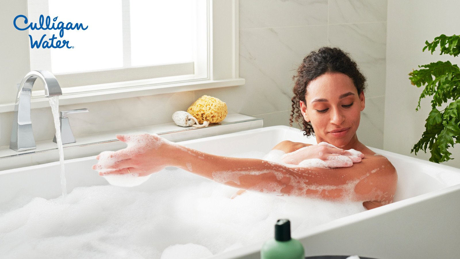 Person taking a bath in soapy water