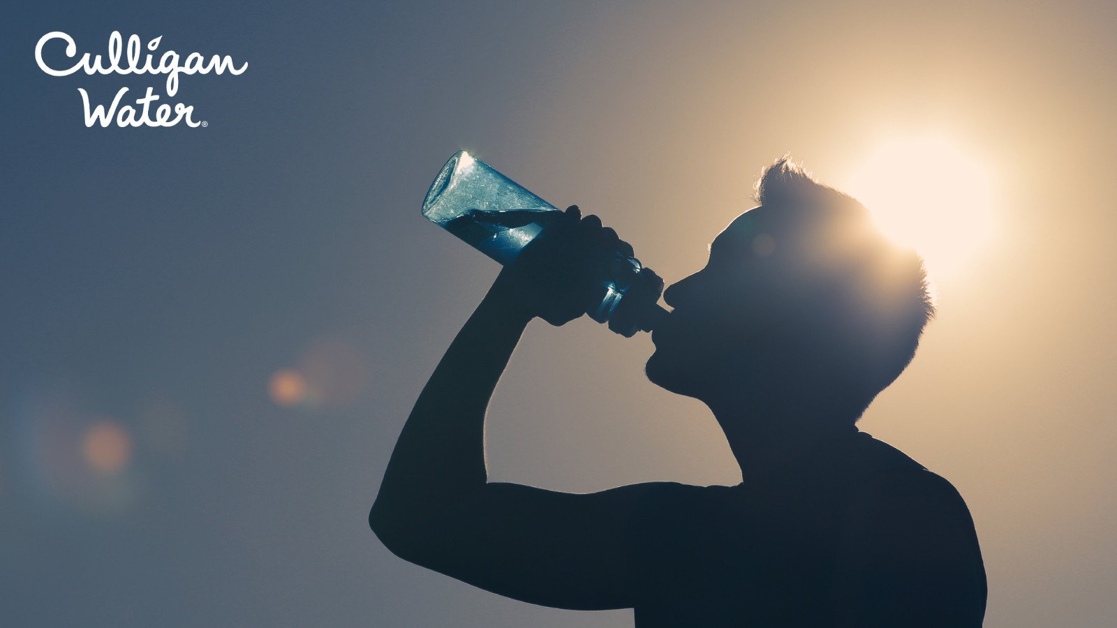 Man drinking water from a reusable sport bottle